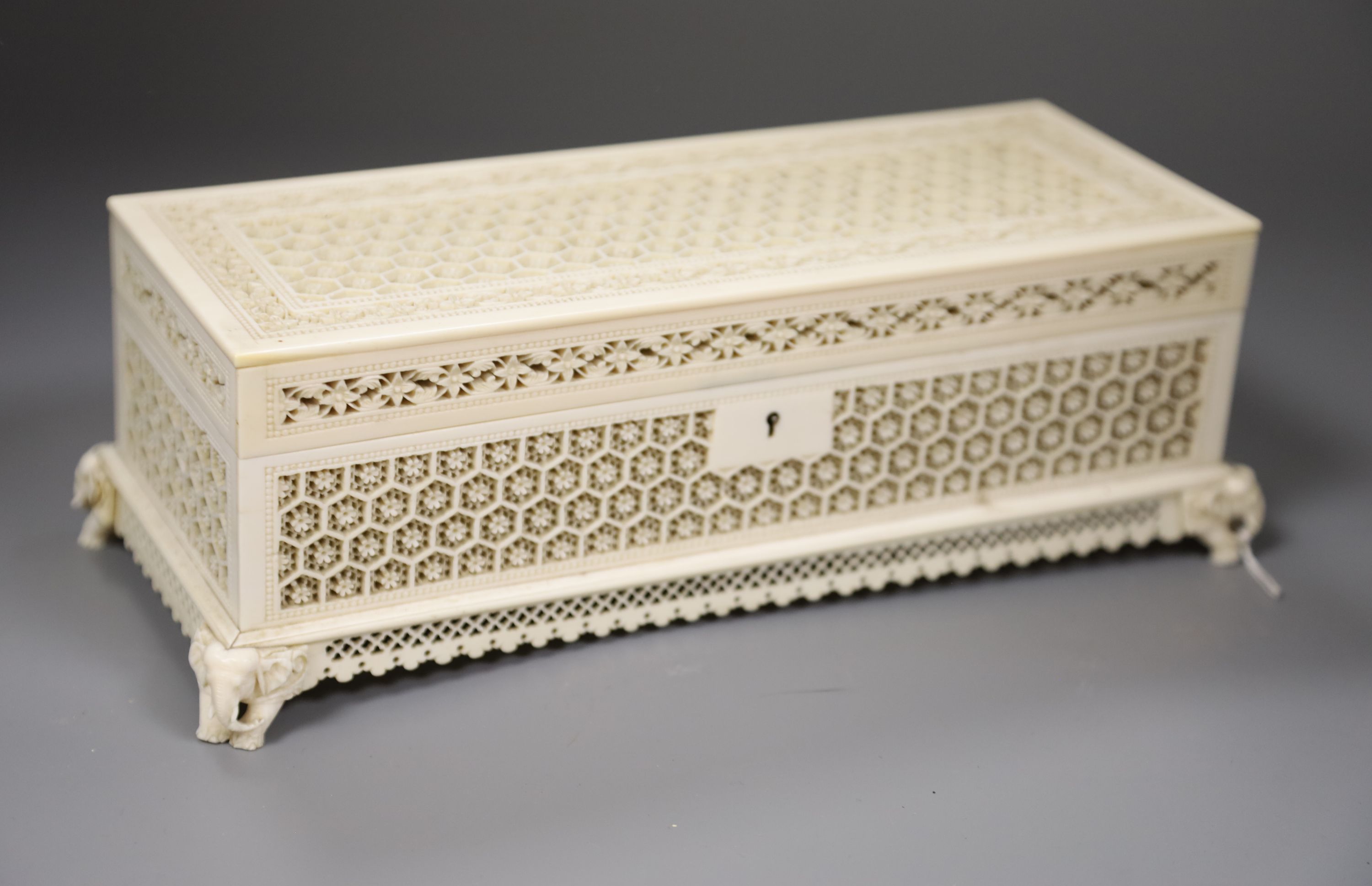 An antique Indian carved ivory casket, length 29cm (no key)